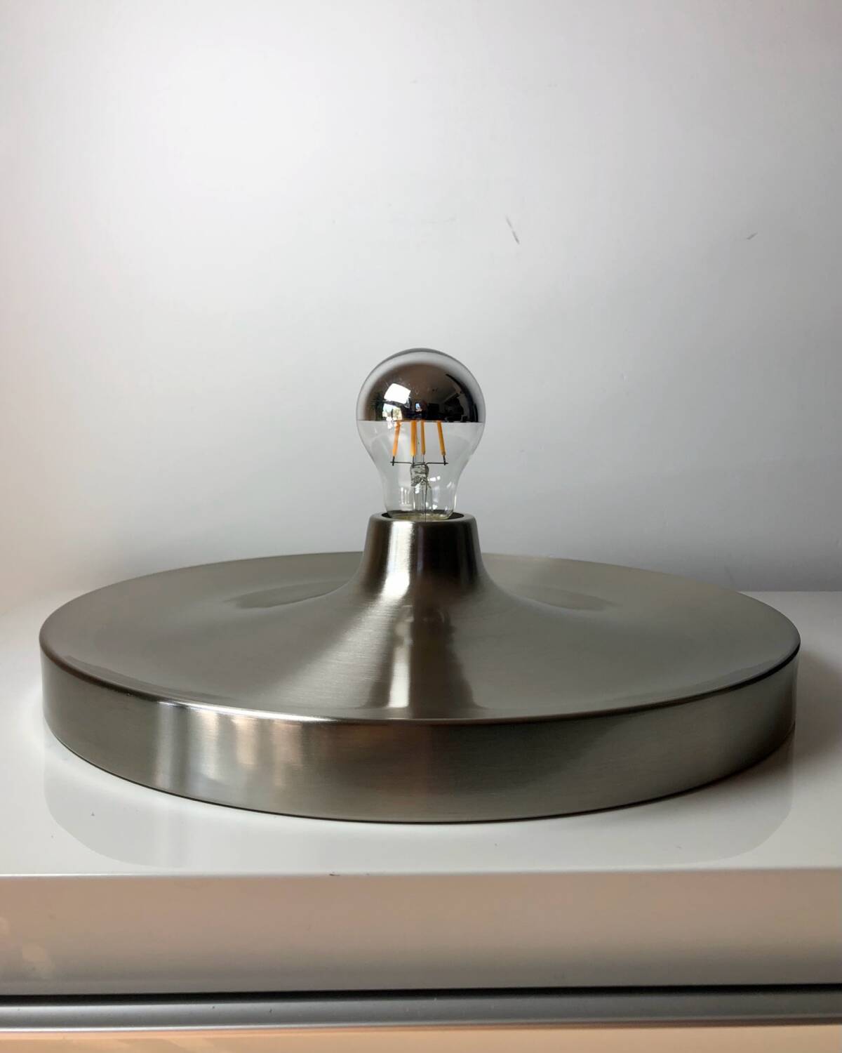 Modernist disc wall sconce