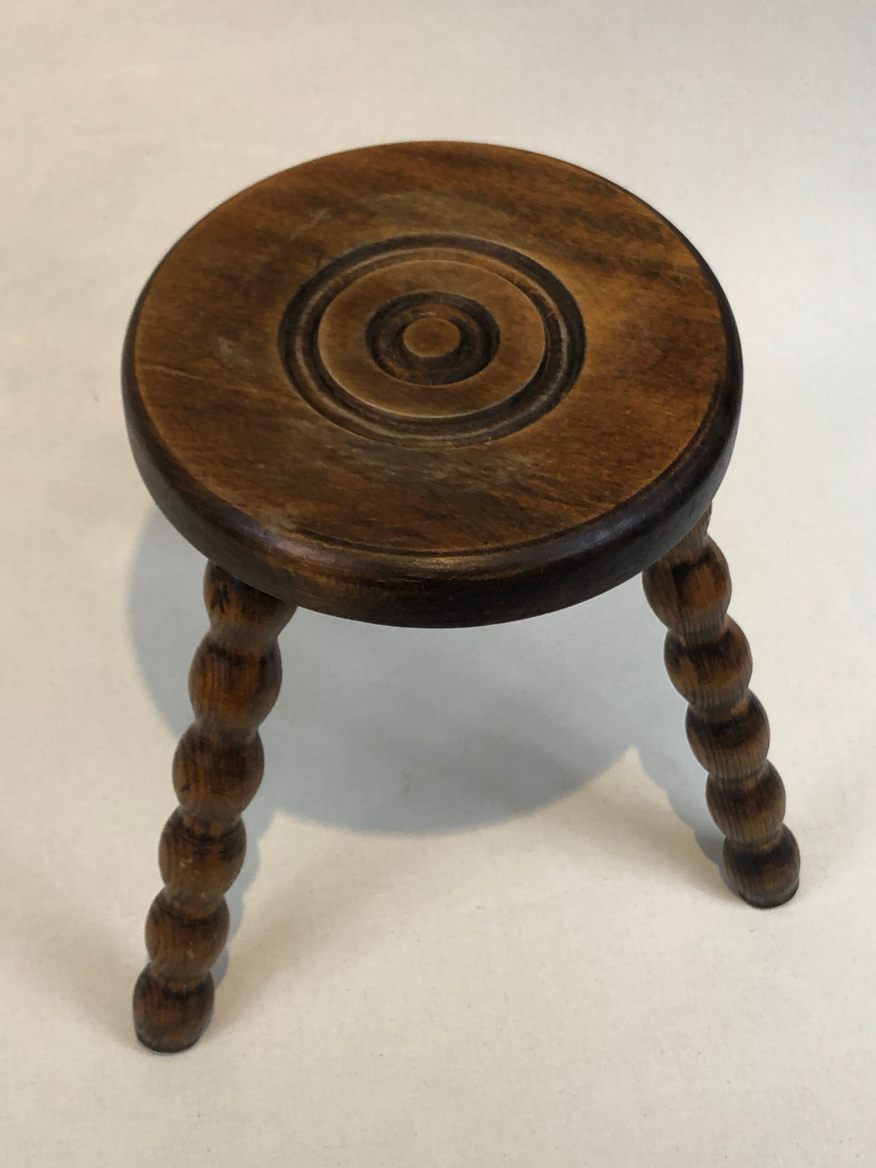 Dark turned wood tripod stool