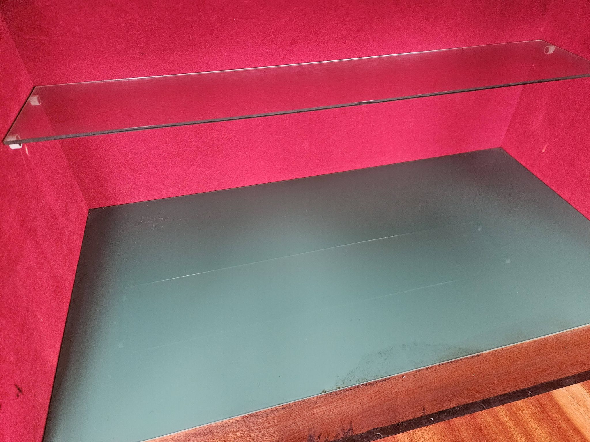 1950s mahogany sideboard with a glass top and central bar.