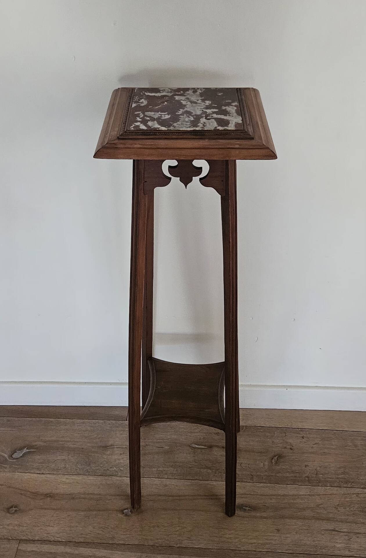 High plant stand in carved wood and Art Nouveau marble.