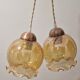 2 iridescent amber luminaires in suspensions