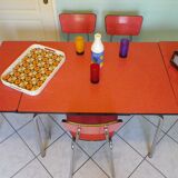 Table in red formica, 4 roc chairs, 2 extension cords, 2 drawers 60