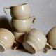 Six vintage potter's ceramic cups with vanilla enamel