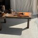 Small rectangular teak monoxyle cutting board with a circular handle.
