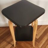 Black lacquered wooden side table with offset tops.