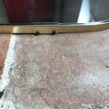 Vintage 1960 free-form mirror known as a retro mirror with a gold and black metal trim.