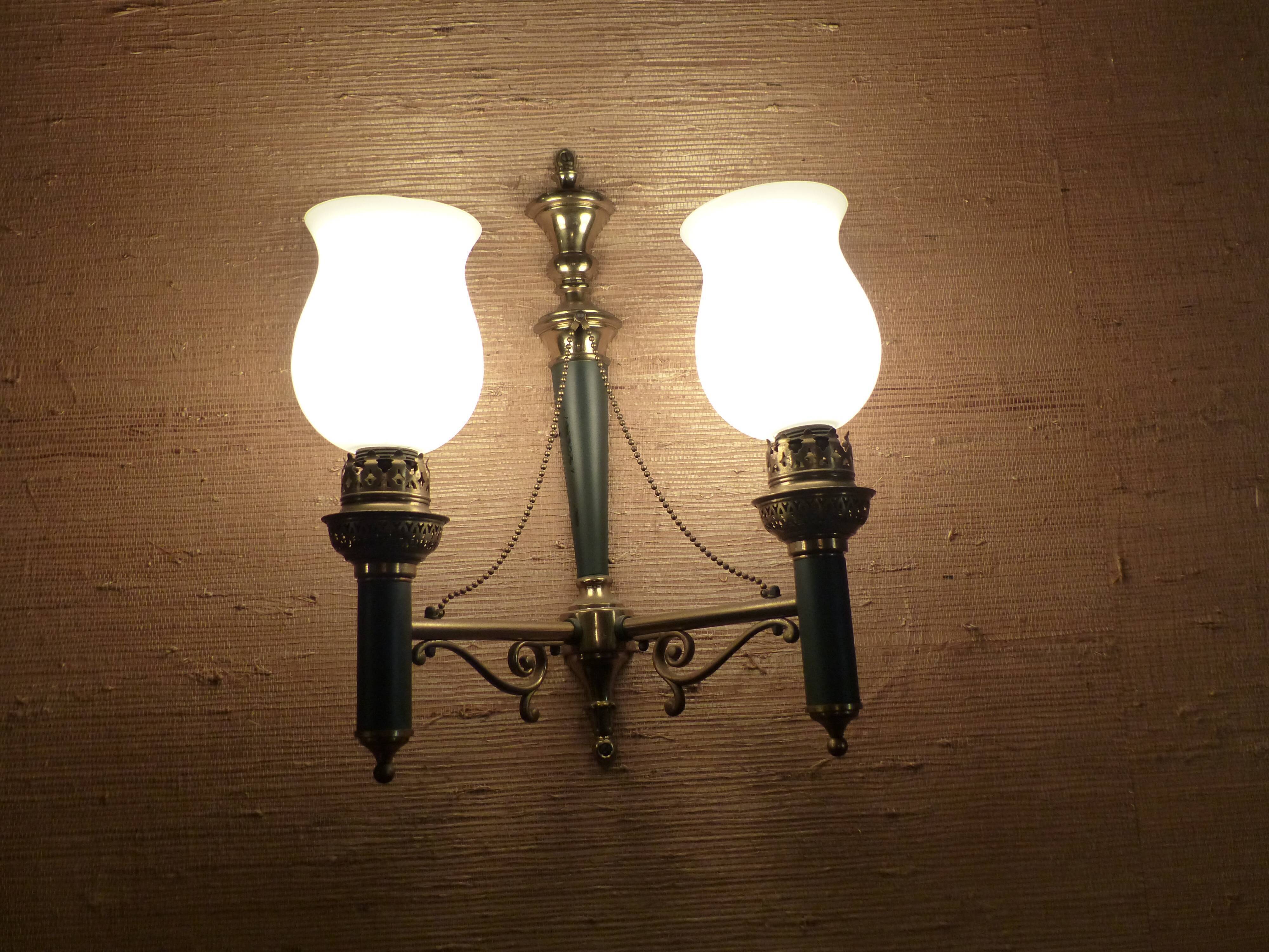 Brass wall sconce and frosted globe