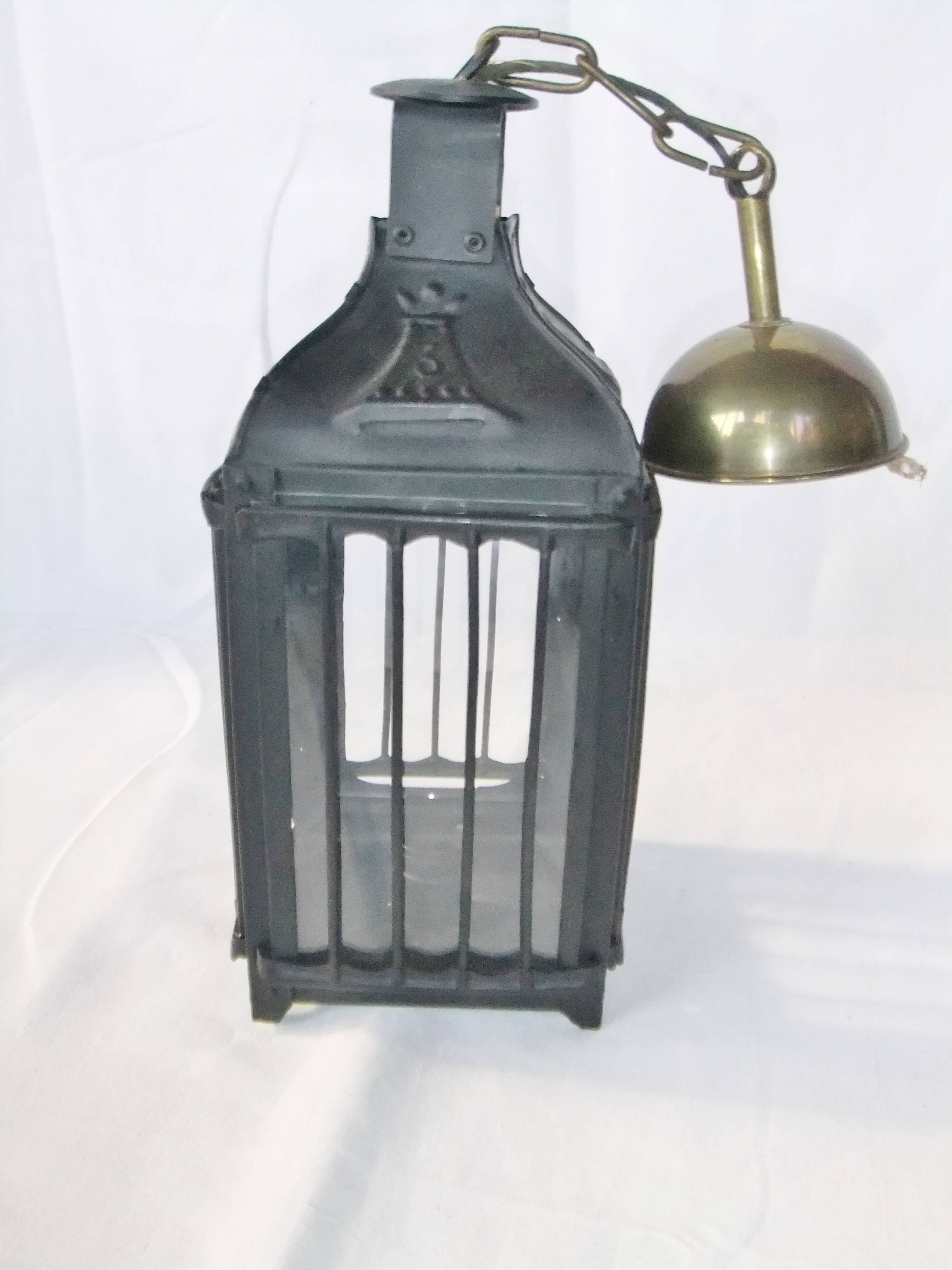 Old chandelier hanging lantern with candle in sheet metal