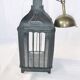 Old chandelier hanging lantern with candle in sheet metal