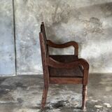 Small antique Indonesian bench in carved teak with plant and floral motifs.