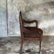 Small antique Indonesian bench in carved teak with plant and floral motifs.