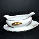 Vintage pouring sauce boat in floral porcelain with gilding.