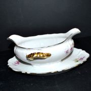 Vintage pouring sauce boat in floral porcelain with gilding.