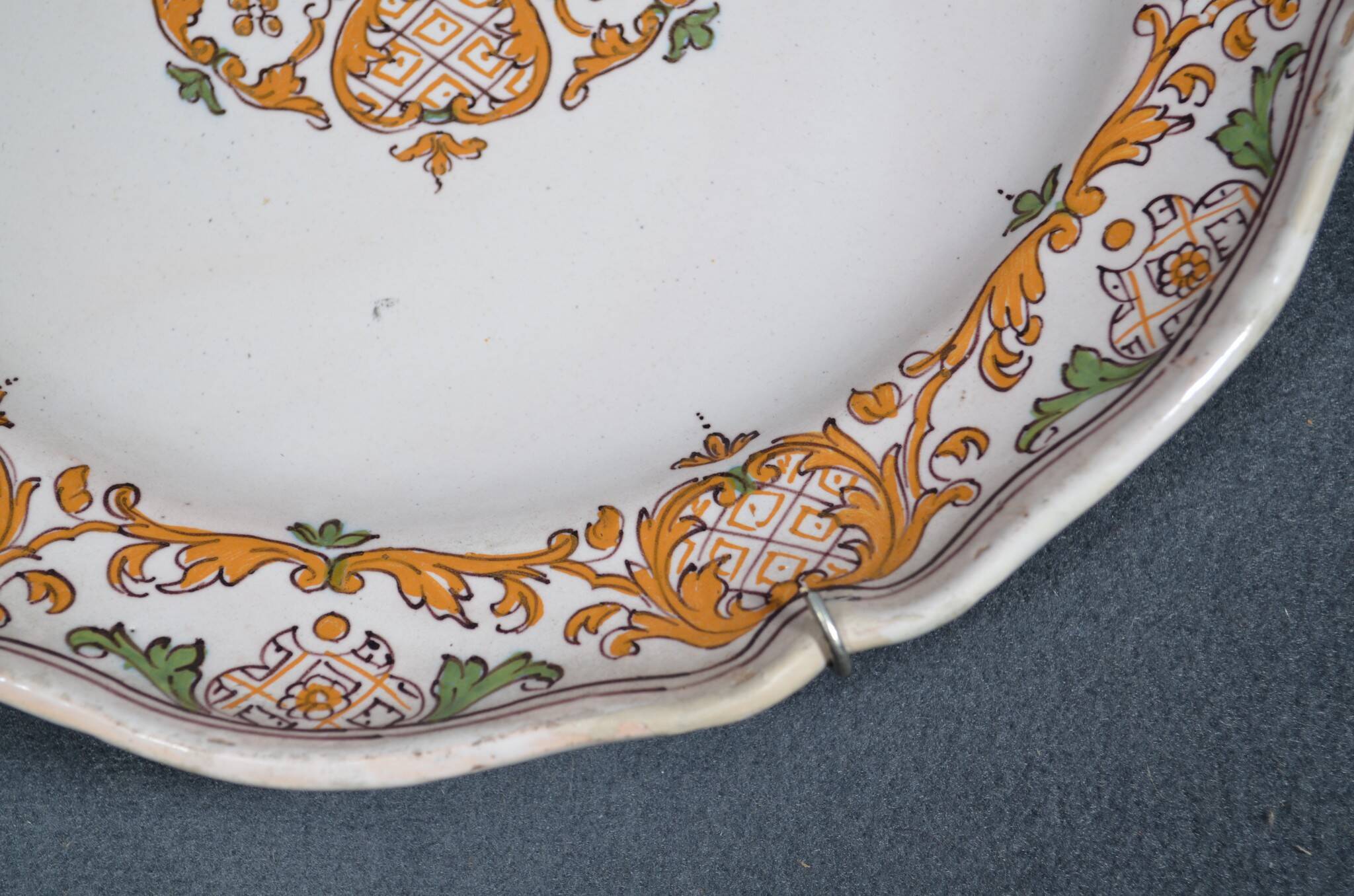 Two 18th century earthenware plates with grand feu decoration in ochre, green and manganese