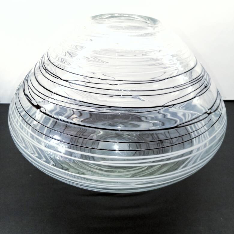 Textured oval blown glass vase with black and white glass spaghetti.
