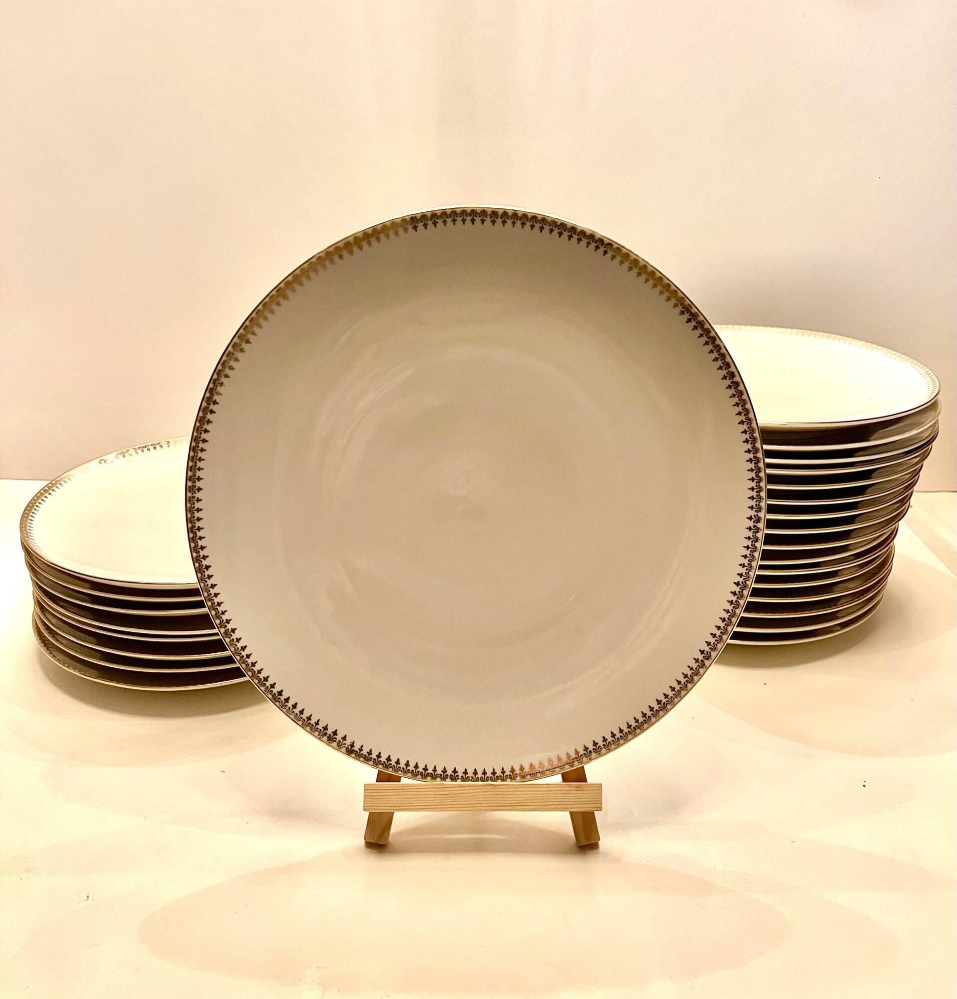 24 plates and a vintage porcelain dish decorated by Lucien Engel.