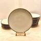 24 plates and a vintage porcelain dish decorated by Lucien Engel.