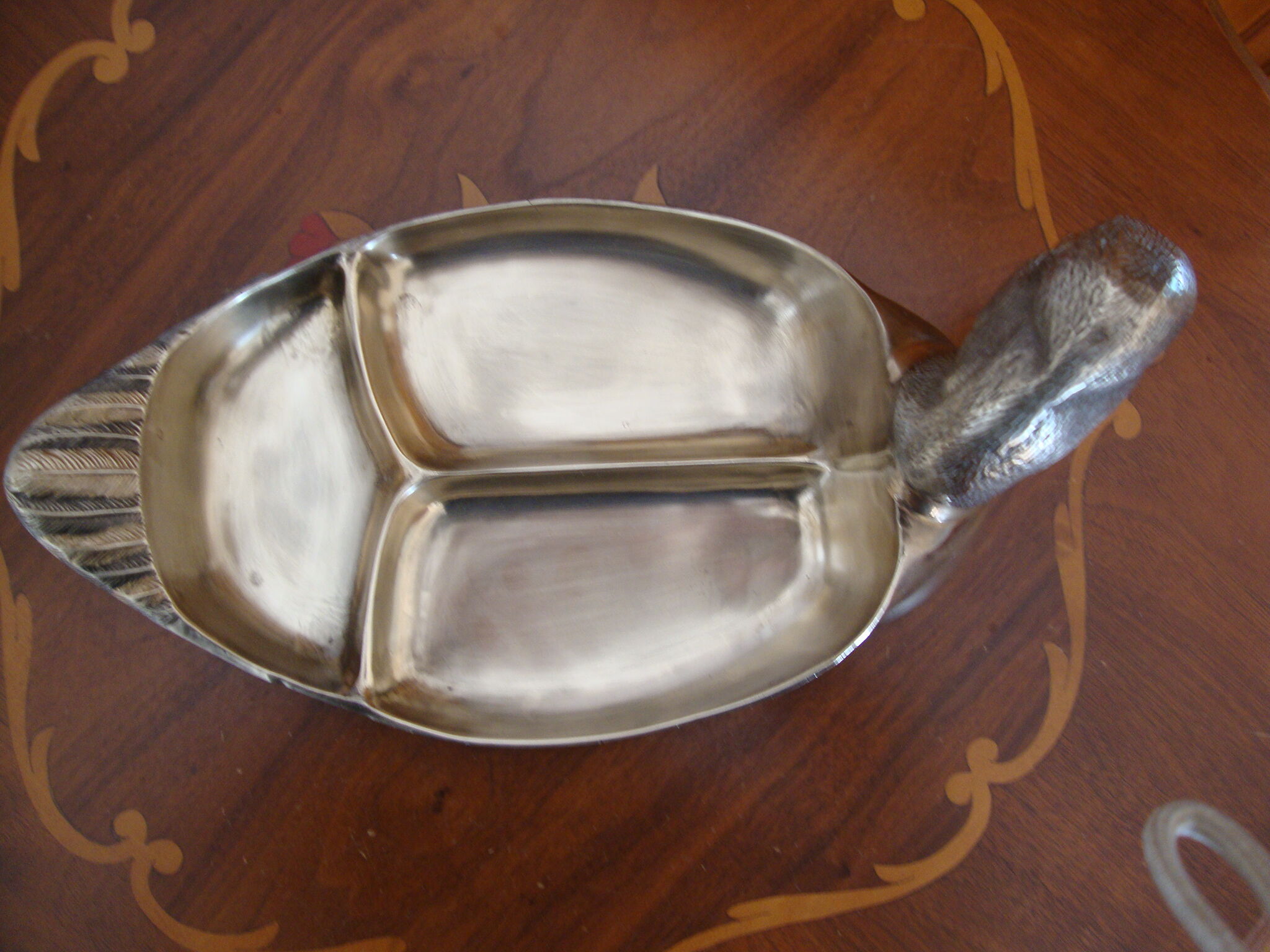 Empty pocketed old duck in solid brass