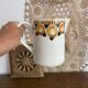 Old ceramic pitcher with orange decoration.