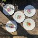 Antique plates from the late 19th century with scalloped edges and fruit decoration.