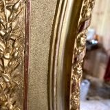 Mirror XIXth medallion on gilded frame with leaf