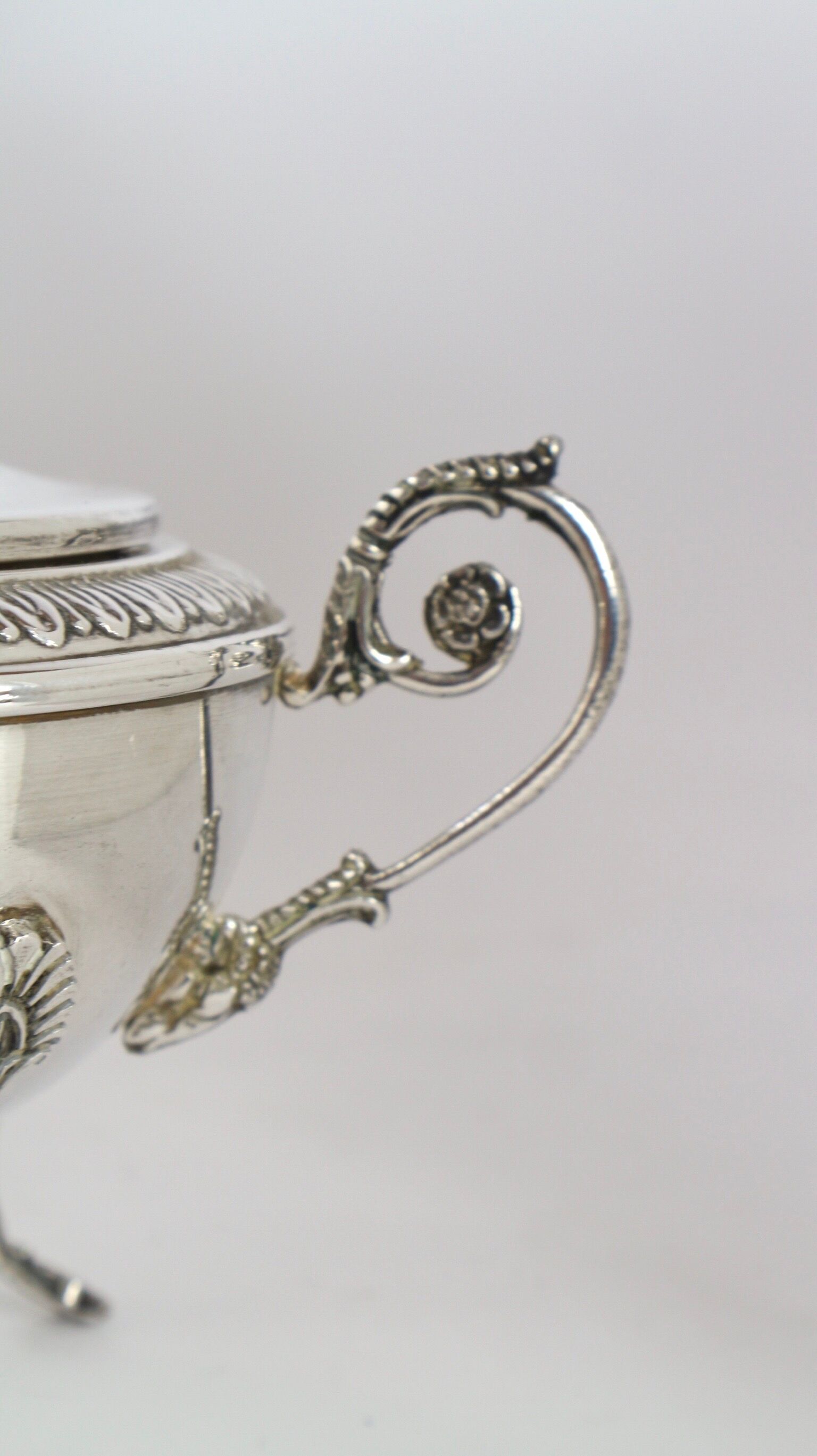 Silver sugar bowl with paw feet and ornate handles