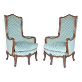 Pair of Louis XV style wingback armchairs with five legs.