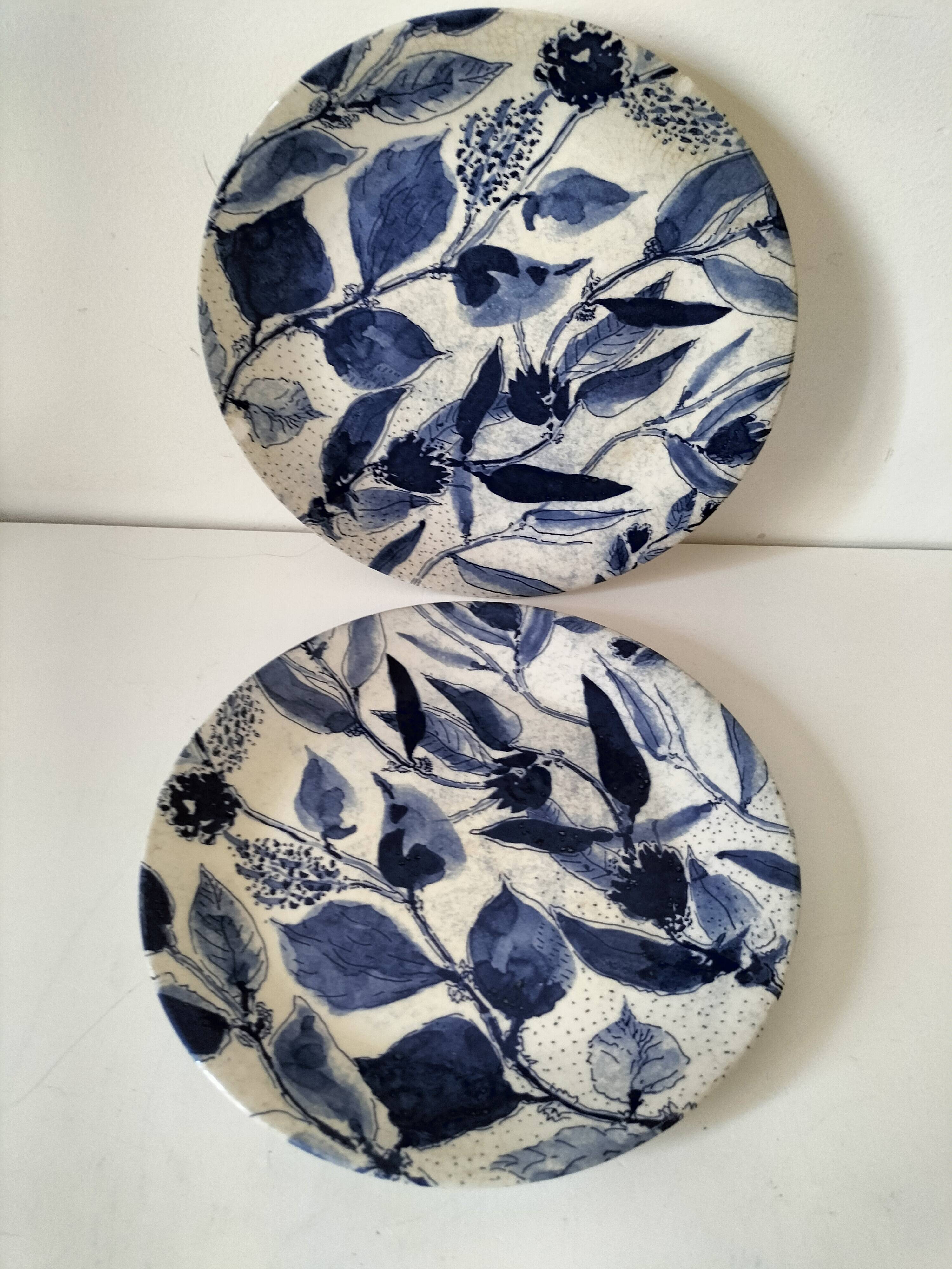 Two flat plates in earthenware with blue floral decoration.