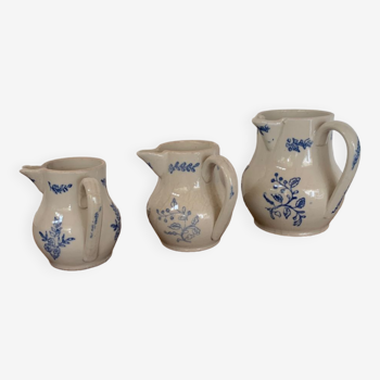 Three decorative ceramic pitchers