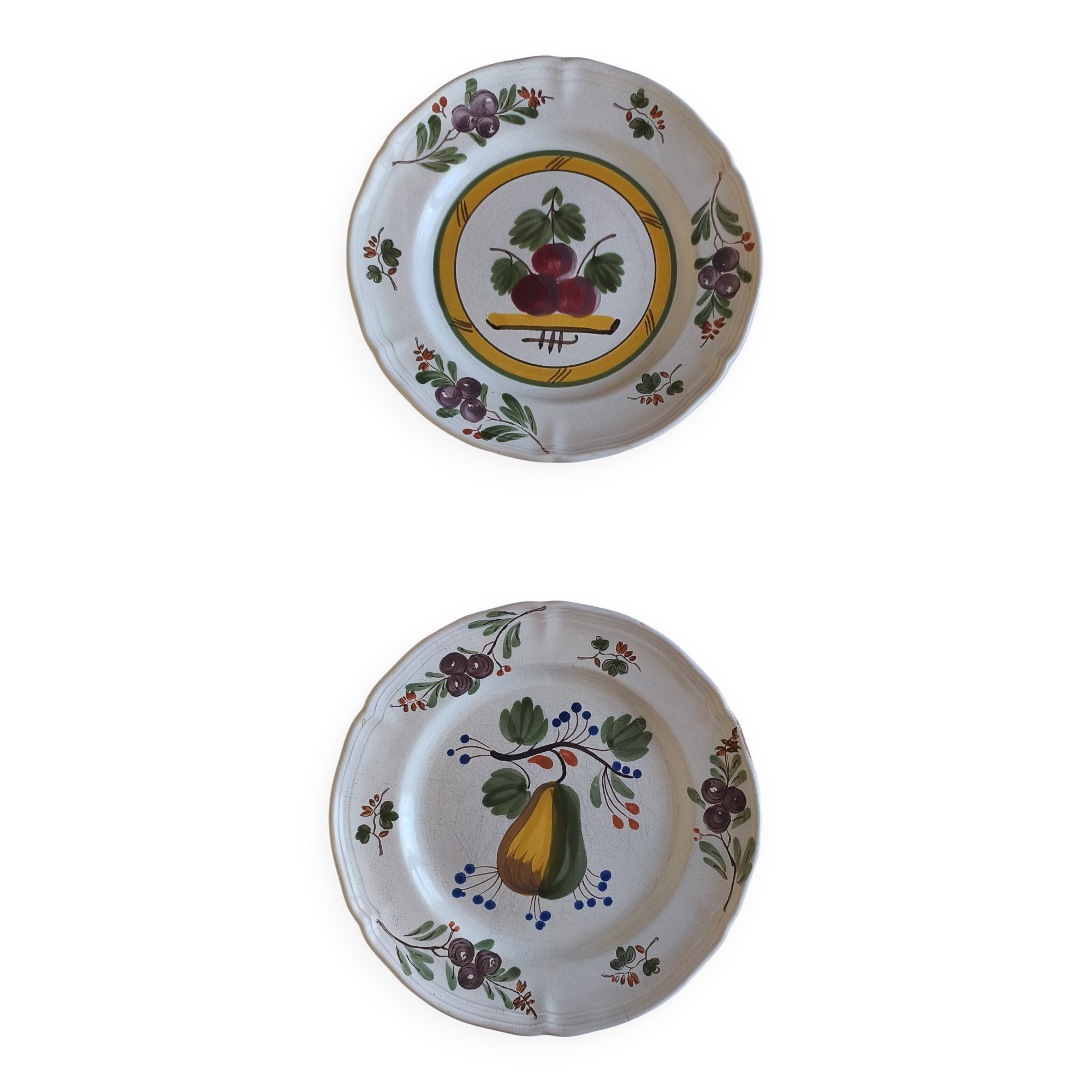 Two earthenware plates with fruits, pears and plums.