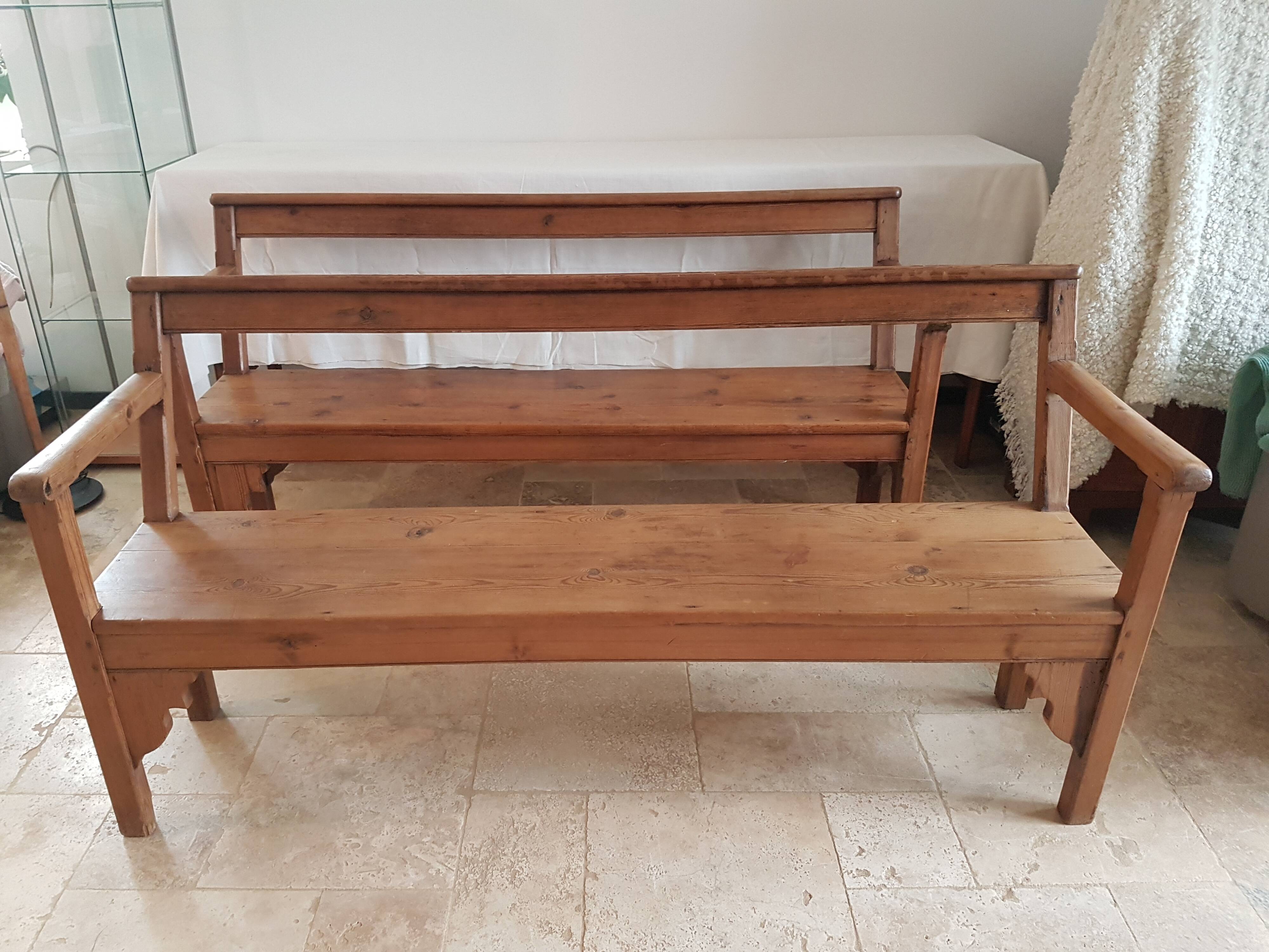 Church bench in fir tree with armrests