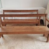 Church bench in fir tree with armrests