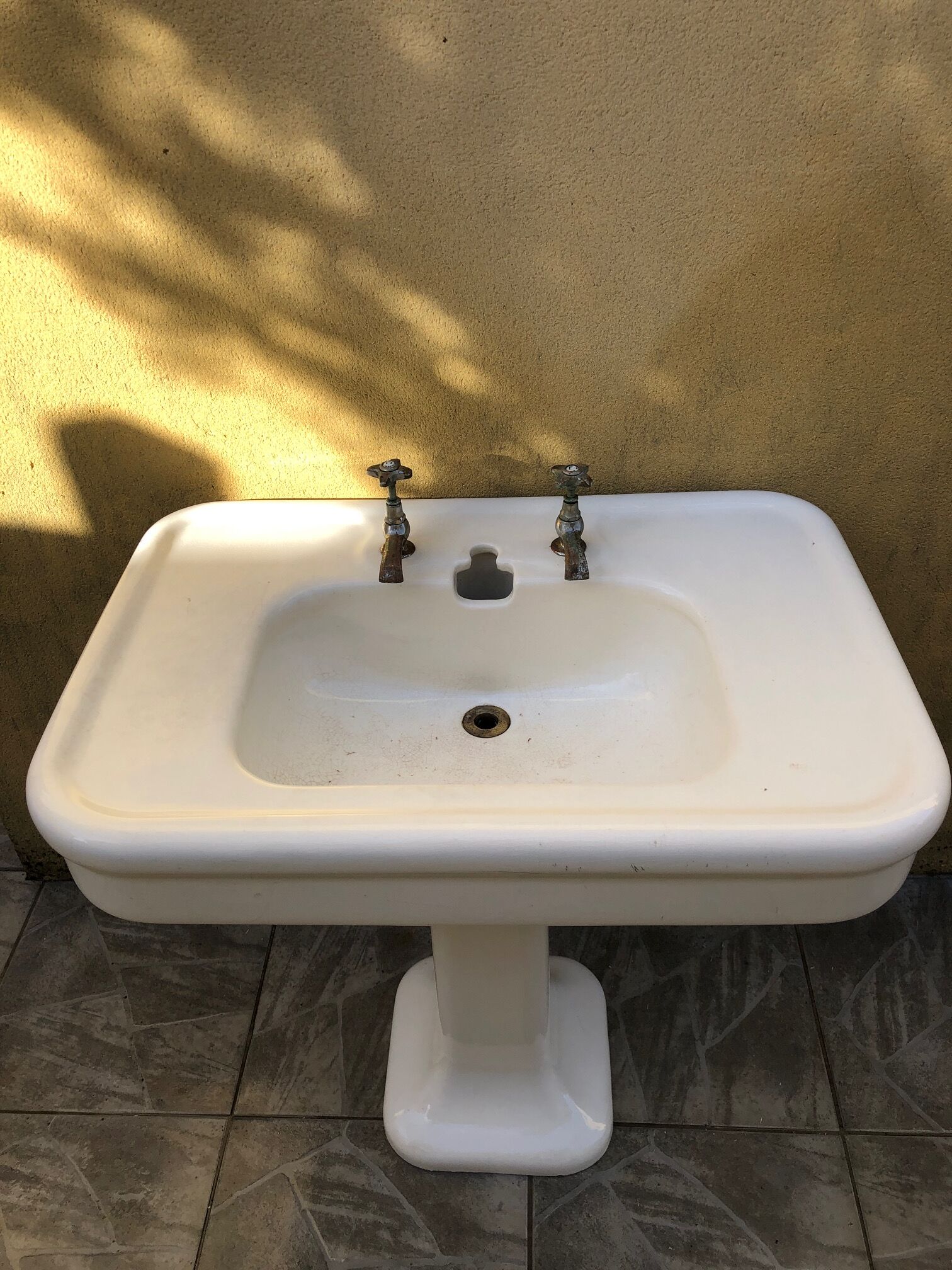 Antique washbasin on ceramic column