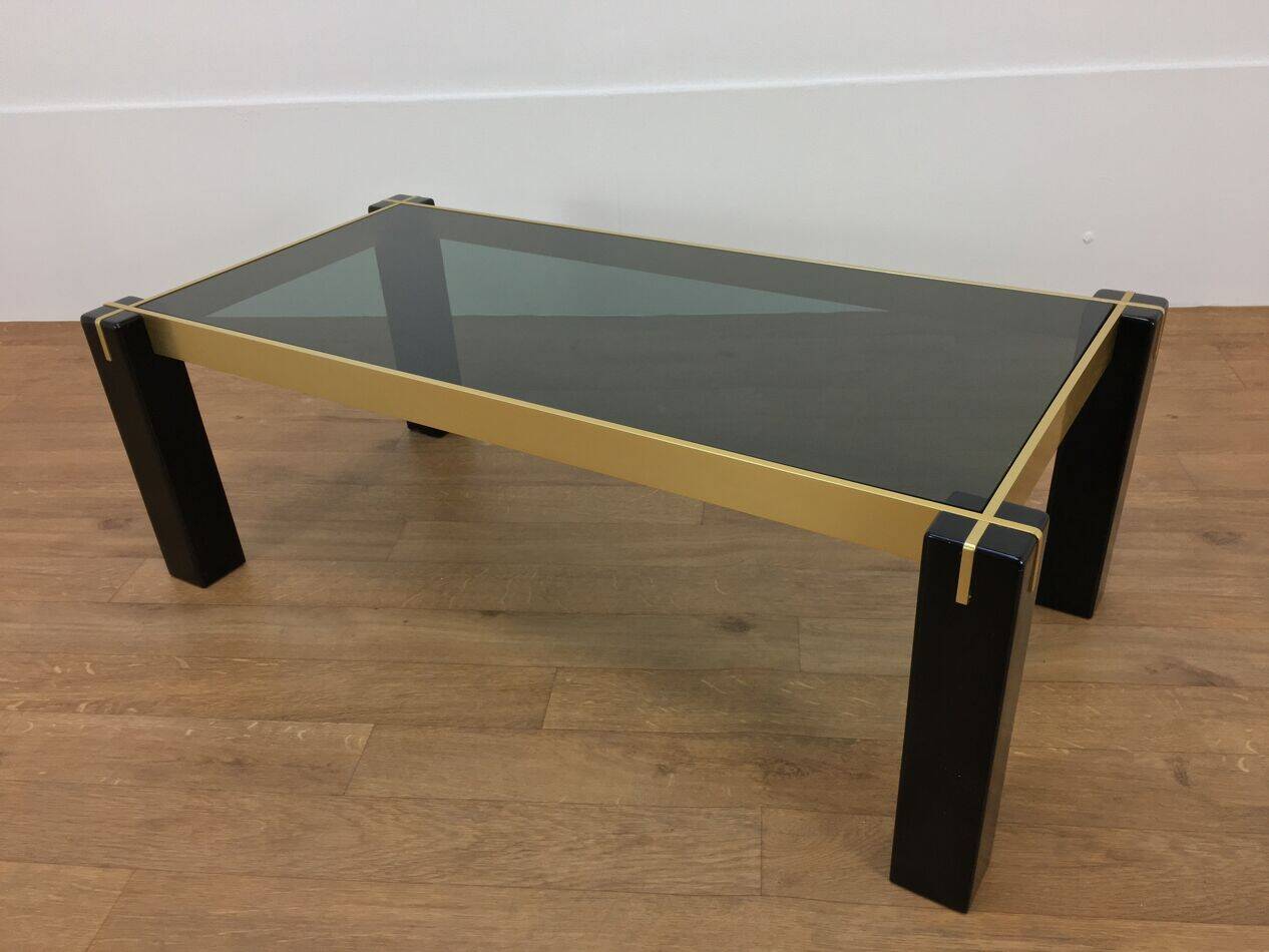 Italian coffee table from the 70s, smoked glass, black and gold lacquered wood.