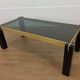 Italian coffee table from the 70s, smoked glass, black and gold lacquered wood.