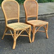 2 rattan and caned chairs in colonial bistro style from the 1990s.