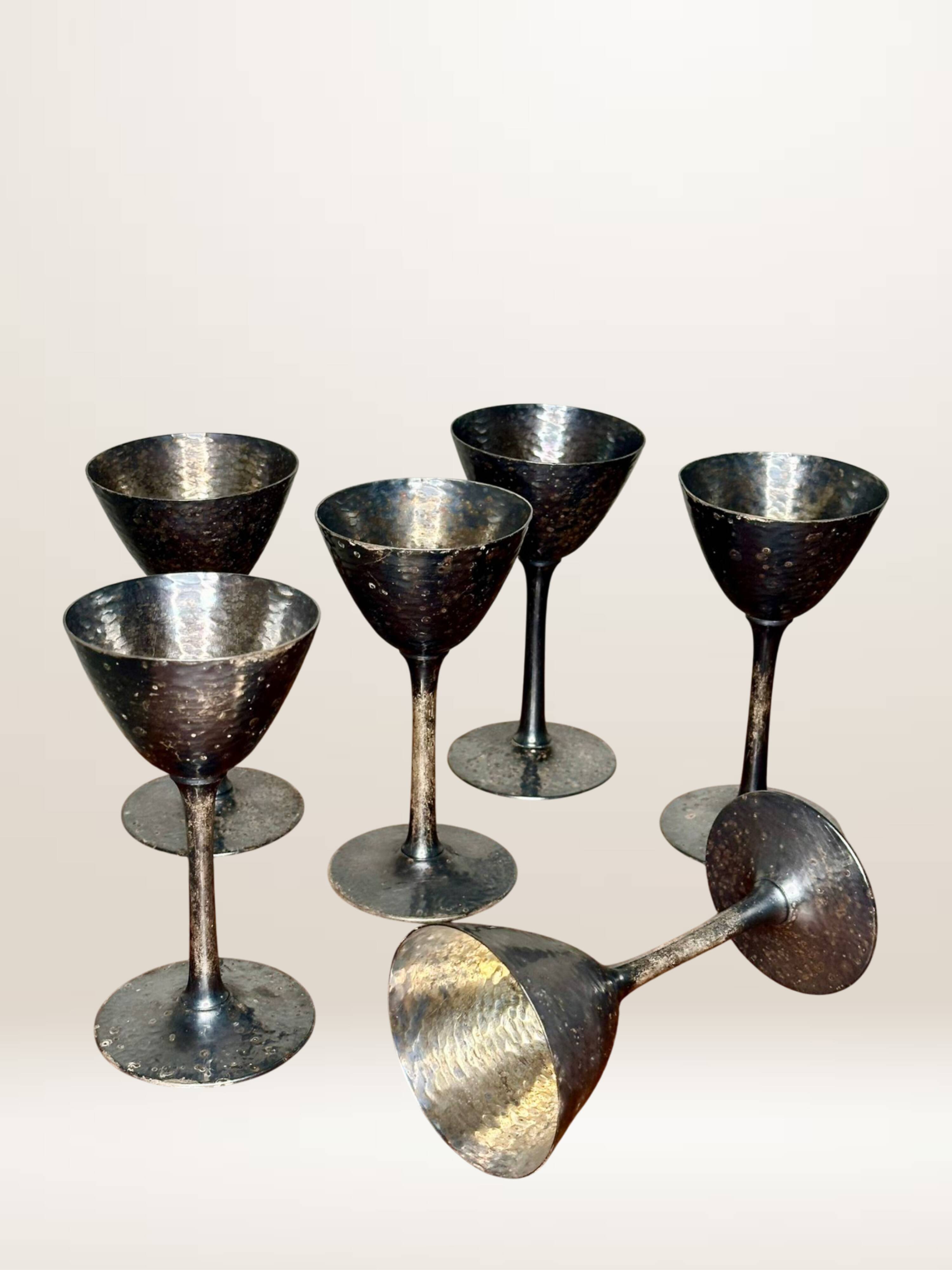 Set of six hammered metal goblets.