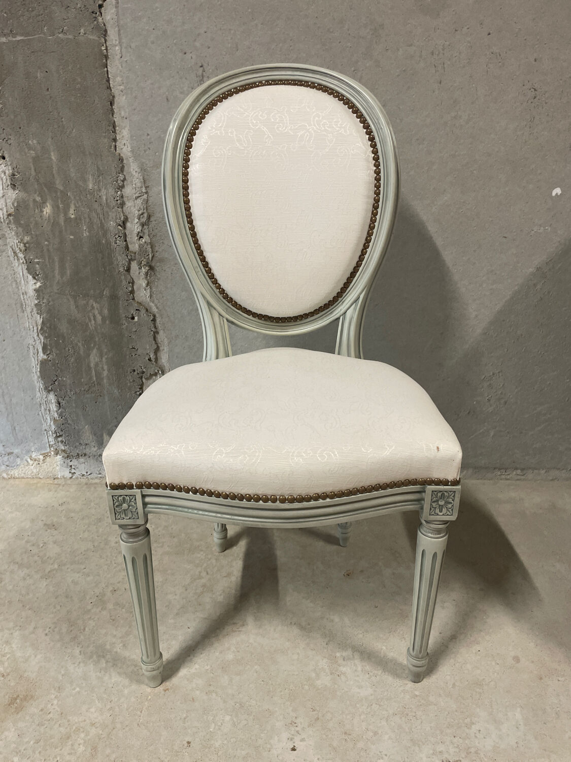 Armchair and 2 chairs set in Louis XVI style, light fabric, patinated wood.