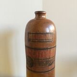 Old stoneware bottle with small handle and labels