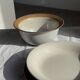 Small thick stoneware bowl with a stylised flower pattern in white on the outside, b