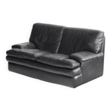 Black leather two-seater sofa. Roche Bobois edition. France, 1980s.