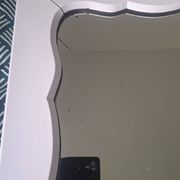 Mid-20th century rectangular wall mirror with a powder pink frame.