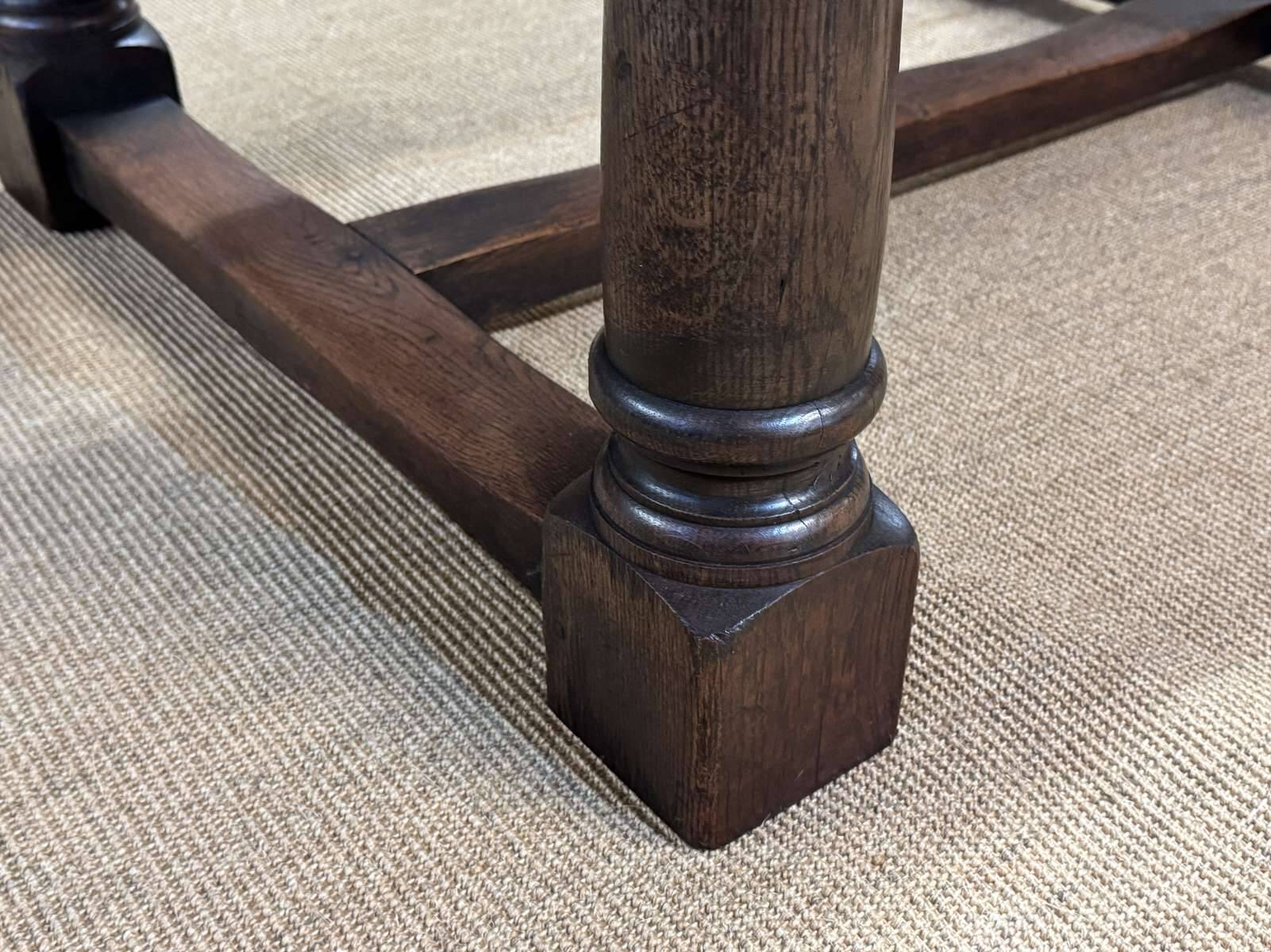 English monastery table with extensions from the late 19th century in elm and oak.