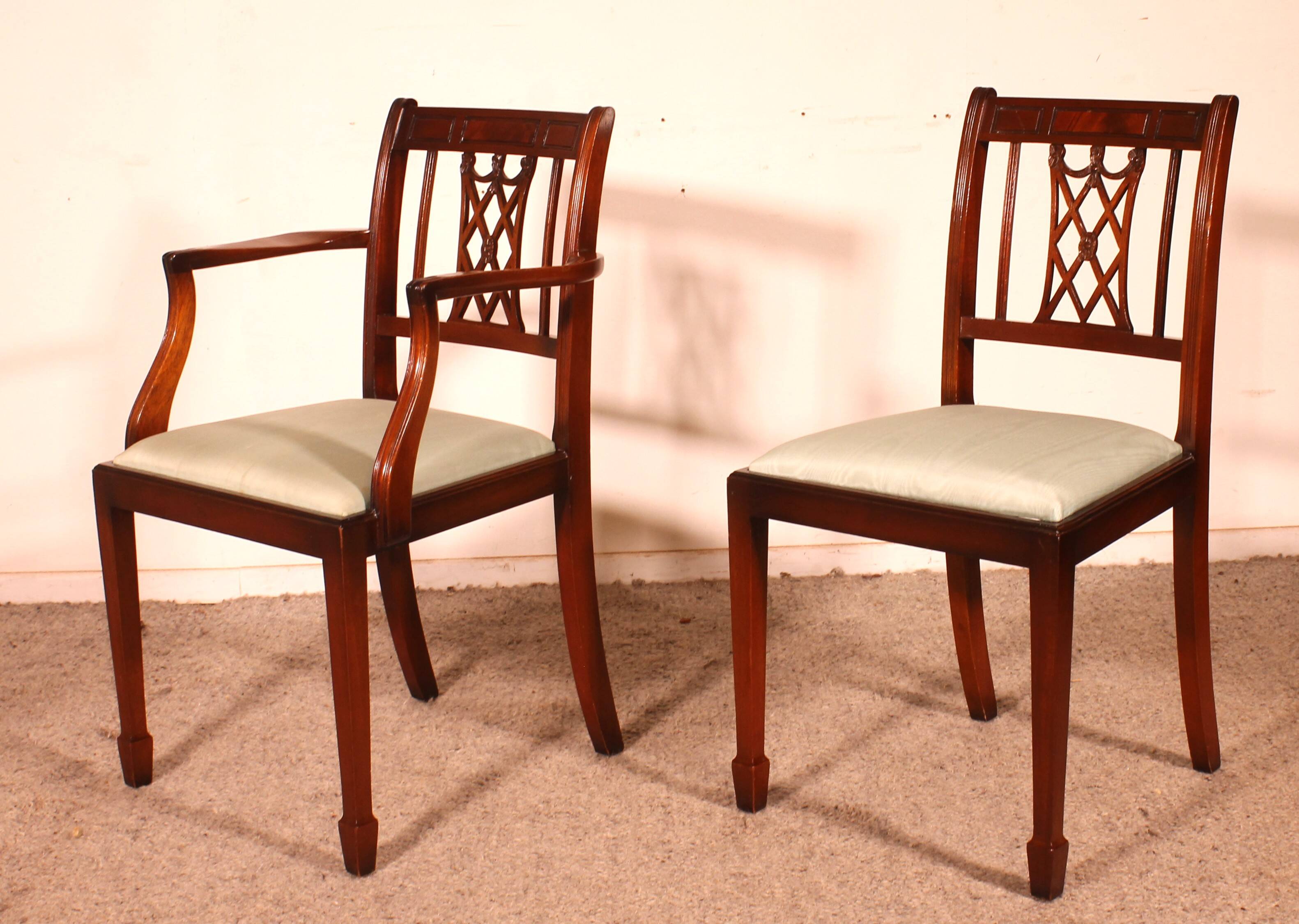 set of 10 chairs and two mahogany armchairs in Hepplewhite style
