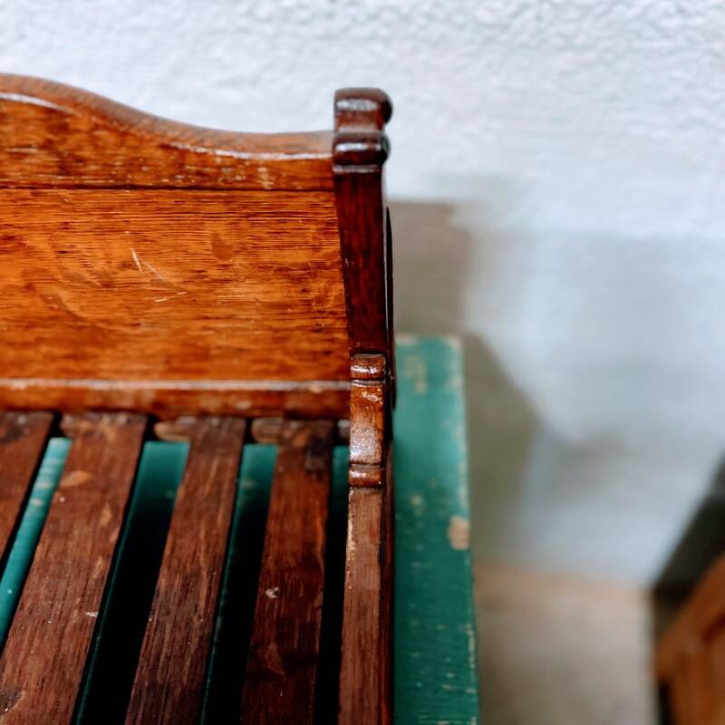 Old doll's bed in varnished wood