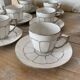 White and silver Limoges porcelain coffee cups and saucers.