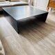 Coffee table with raw metal steel leaf.