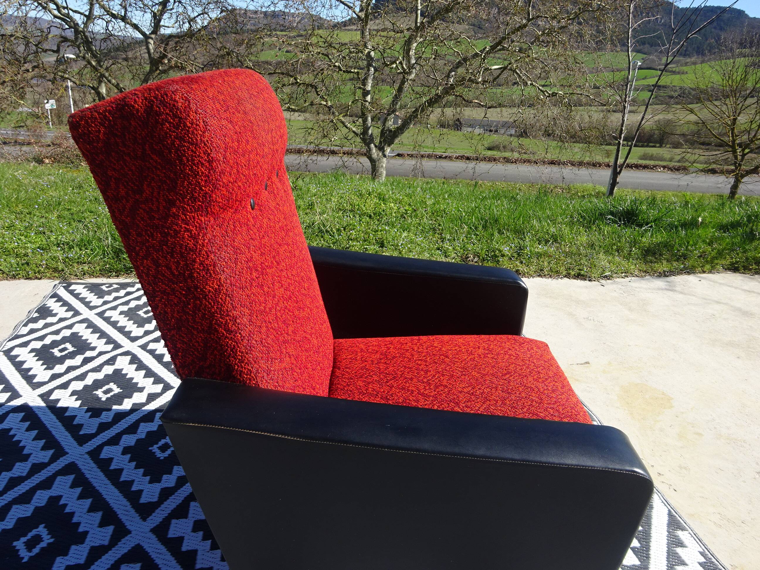 Vintage armchairs in red and black faux leather, the pair.