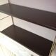 Golden and brown stringed shelf in metal