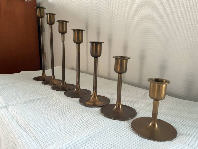 Set of 7 vintage brass candlesticks.